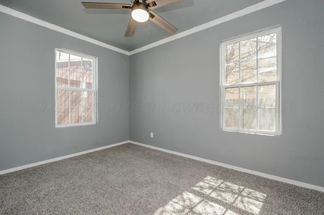 a view of an empty room with windows