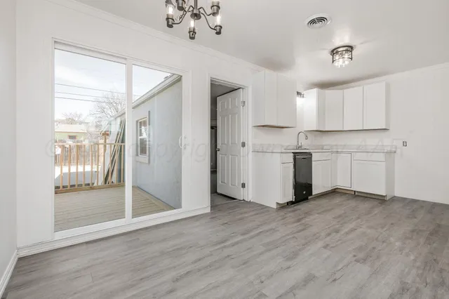 a view of a kitchen with a white cabinet and a stove top oven