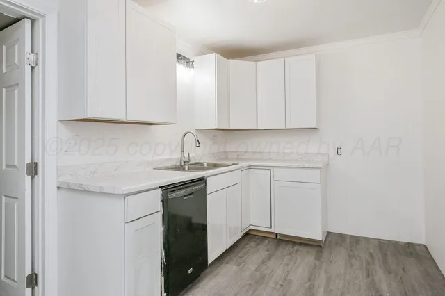 a kitchen with a sink cabinets and window