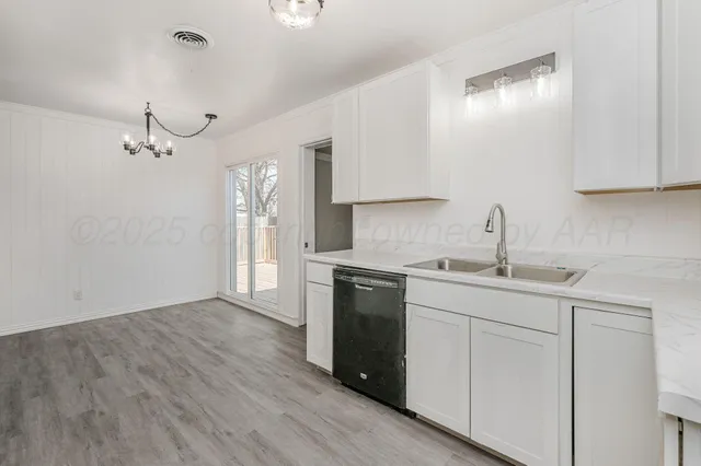 a kitchen with a sink cabinets and window
