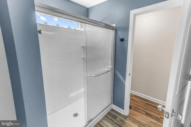 a bathroom with a glass shower door