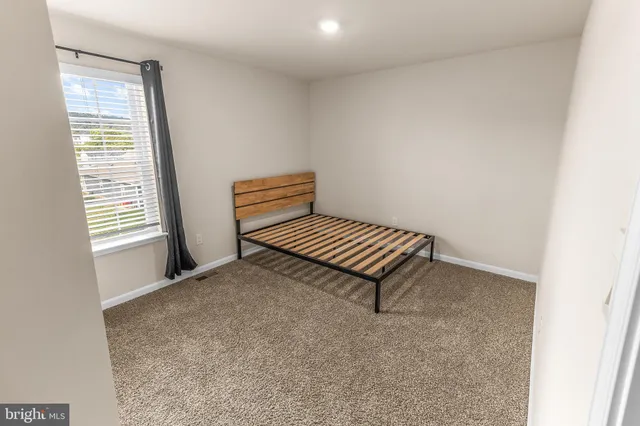 a view of a room with a piano and wooden floor