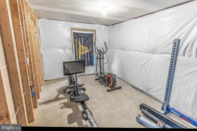 a room with gym equipment and view of living room