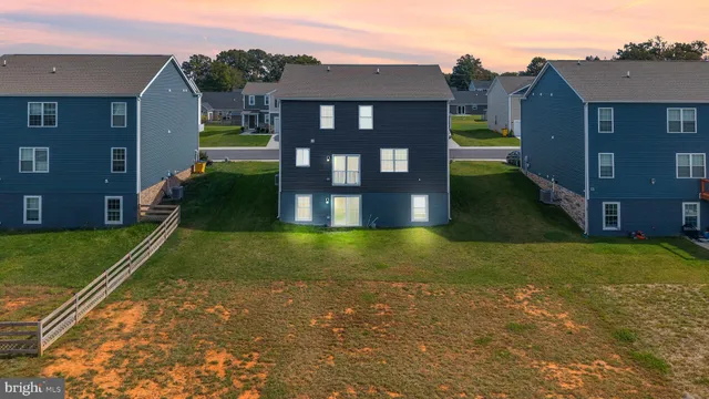 a view of a house next to a yard with a fountain