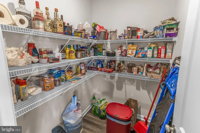 a utility room with lots of clutter and refrigerator