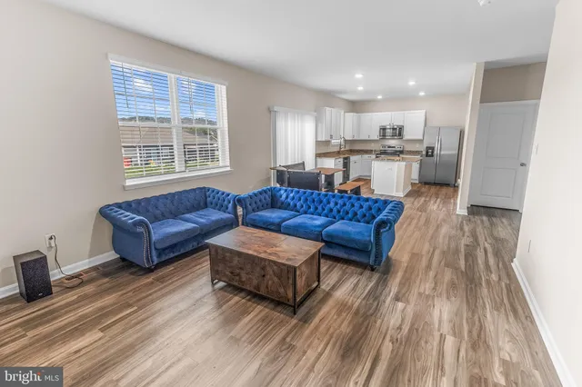 a living room with a couch and a wooden floor