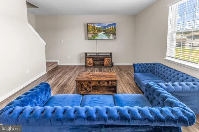 a living room with furniture and a rug