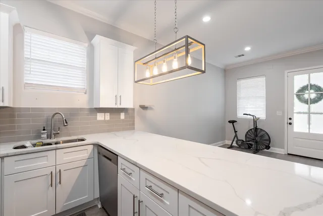 a kitchen with a sink cabinets and window