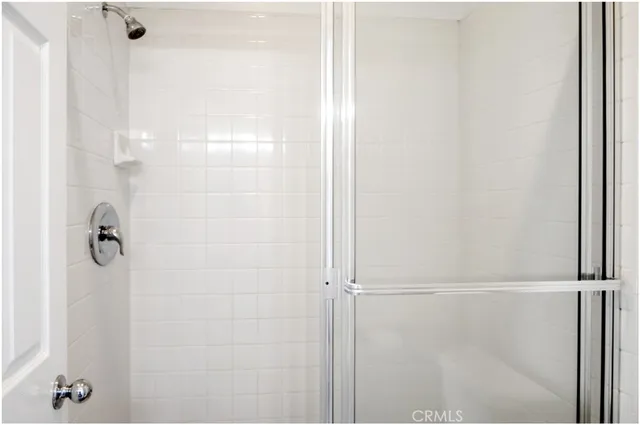 a bathroom with a glass shower door