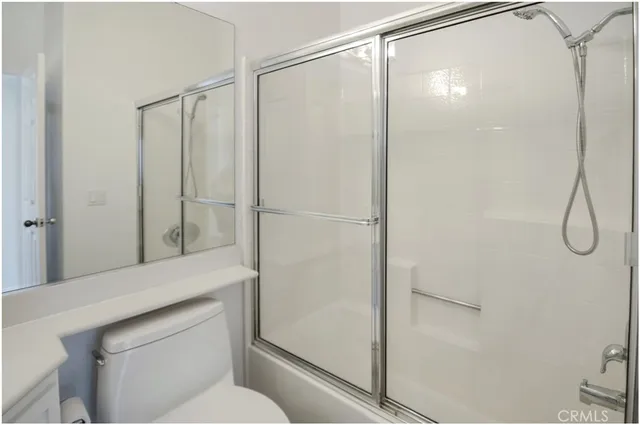 a bathroom with a shower and a toilet