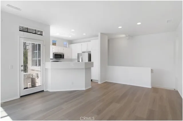 a view of a kitchen with wooden floor