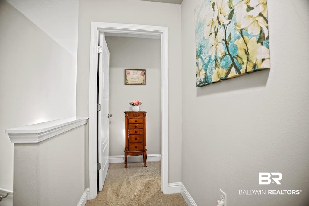 25806 Pollard Road, Unit 27 Daphne, AL 36526 - Photo 28 of 46 Hallway with light colored carpet and baseboards