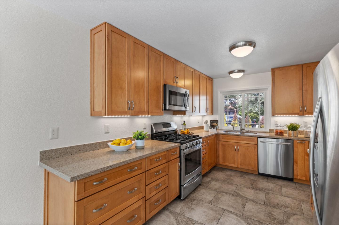 Cadburry Court San Jose, CA 95123 - Photo 11 of 25 a kitchen with stainless steel appliances granite countertop stove top oven a sink dishwasher and a refrigerator