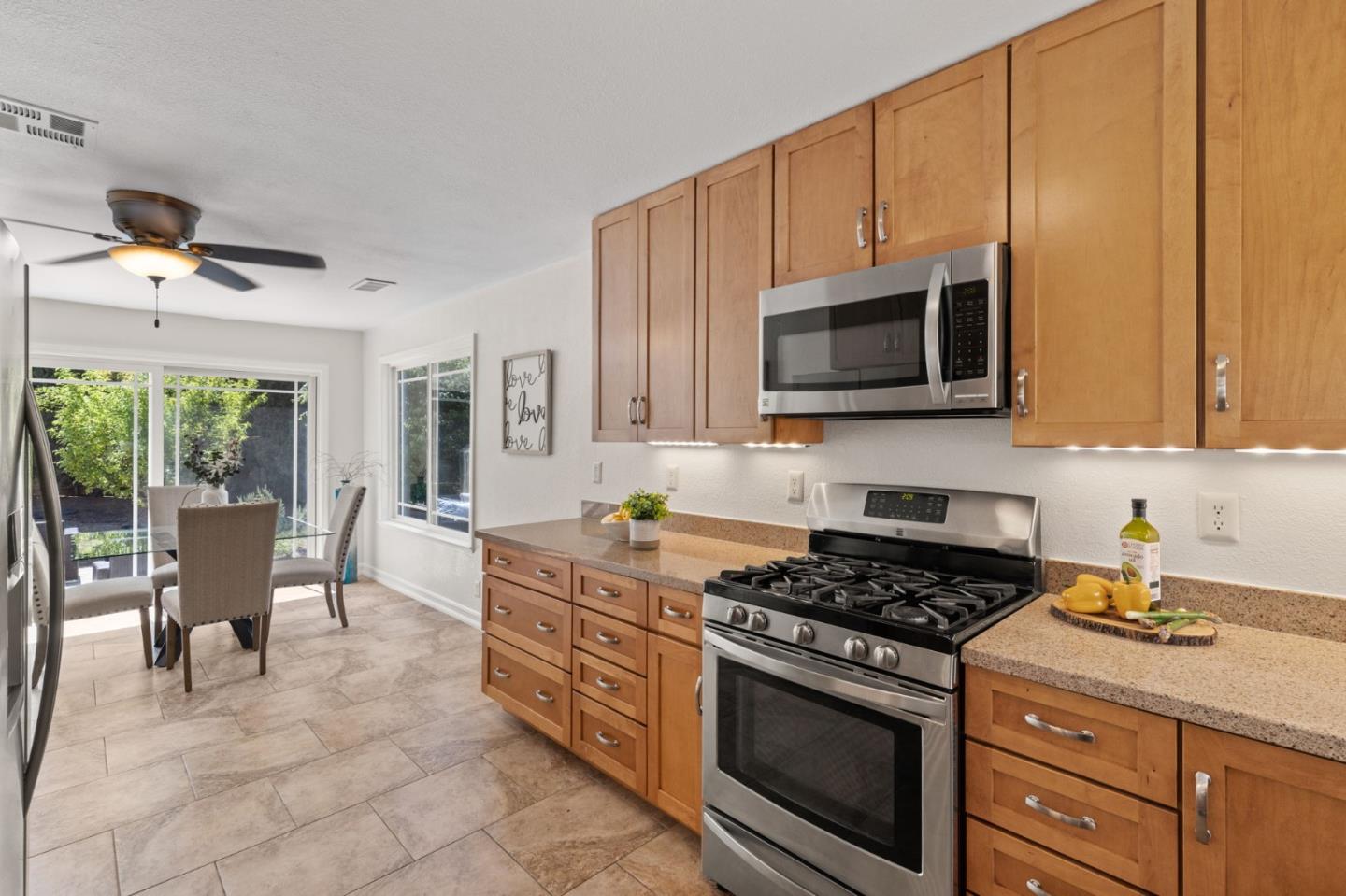Cadburry Court San Jose, CA 95123 - Photo 12 of 25 a kitchen with stainless steel appliances a stove a sink cabinets and a microwave