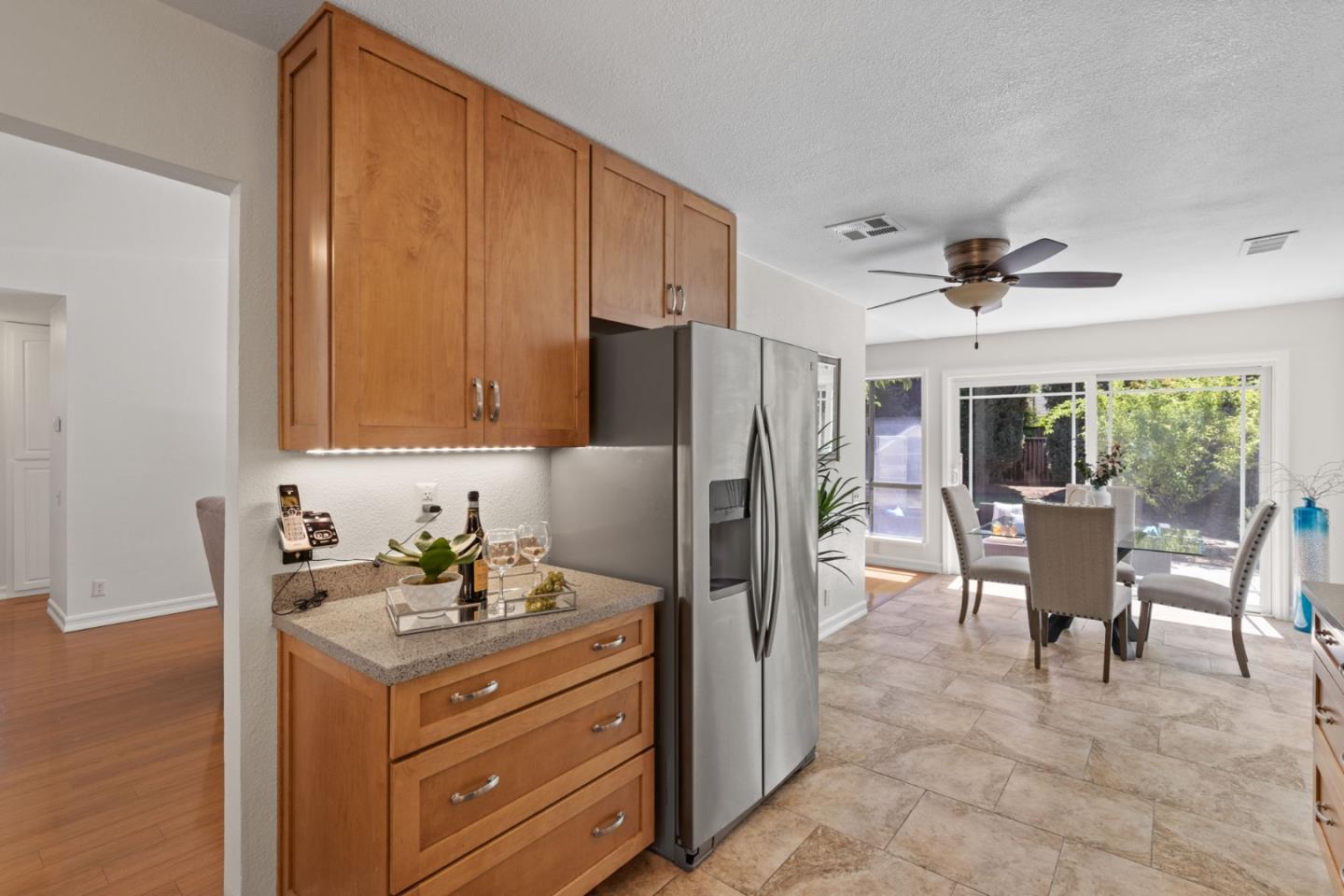 Cadburry Court San Jose, CA 95123 - Photo 13 of 25 a kitchen with stainless steel appliances granite countertop a refrigerator a sink a dining table and chairs with wooden floor