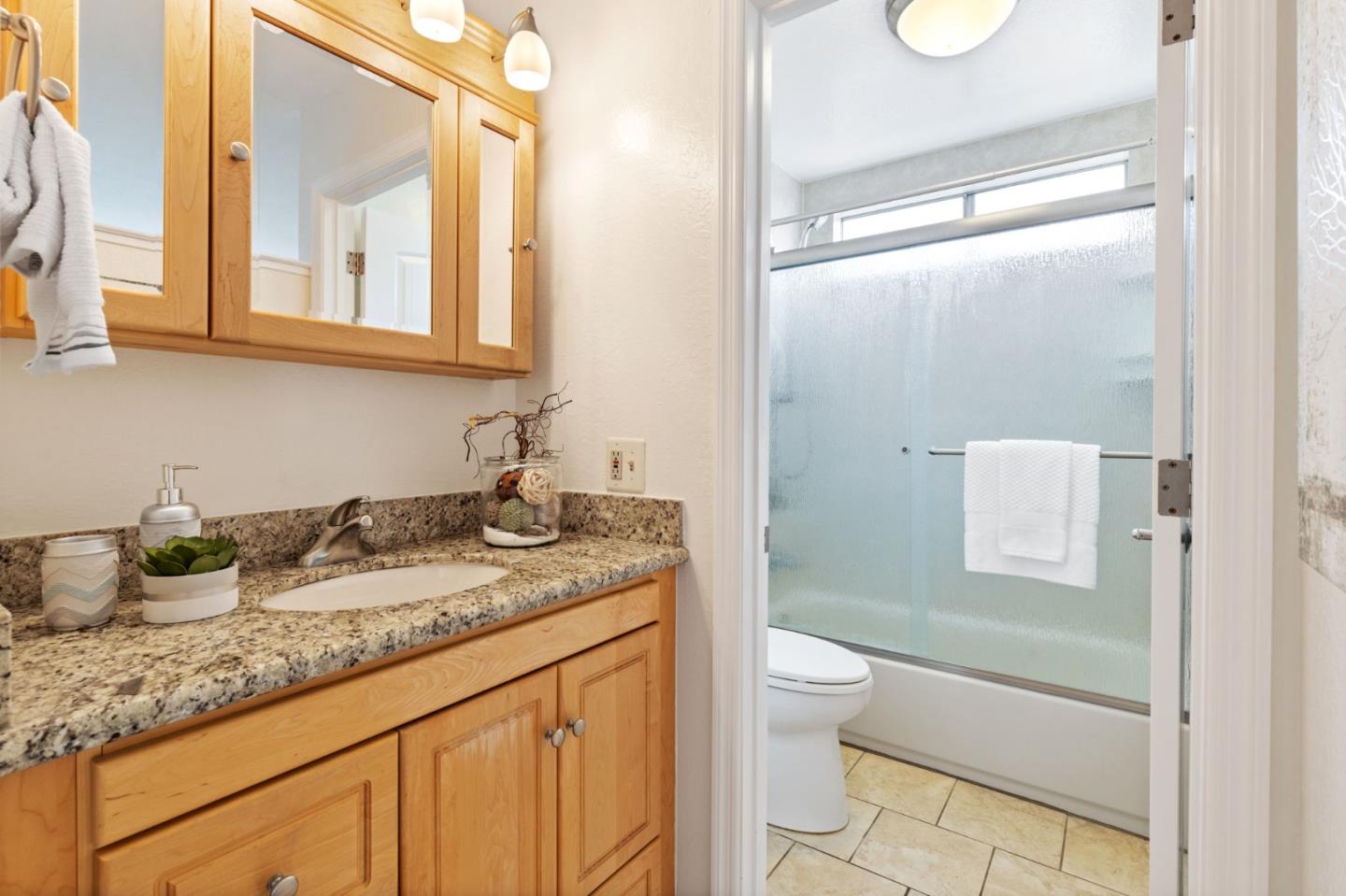 Cadburry Court San Jose, CA 95123 - Photo 16 of 25 a bathroom with a granite countertop sink a toilet and a mirror
