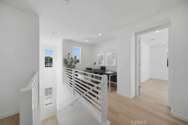 a view of a kitchen with a sink wooden floor and living room