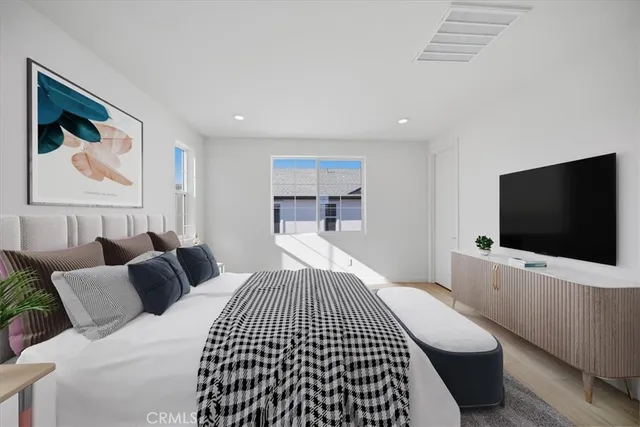 a bedroom with a bed and a flat screen tv