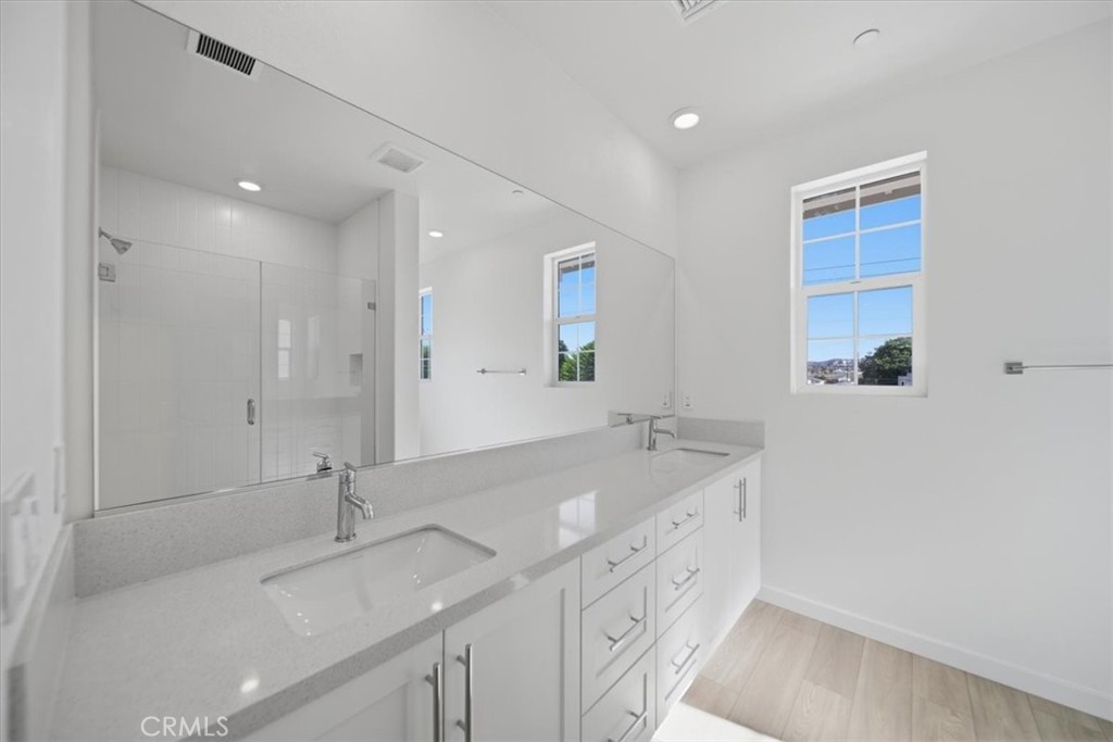 4841 East Beltramo Ranch Road Moorpark, CA 93021 - Photo 16 of 38 a bathroom with a sink double vanity granite tub and a mirror