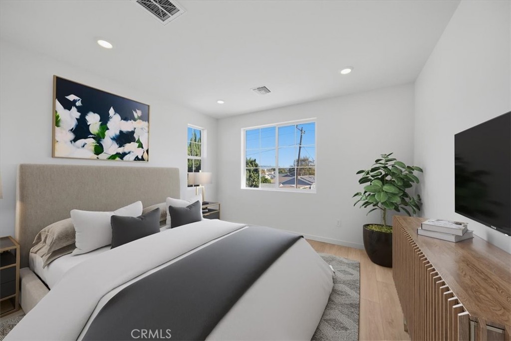 4841 East Beltramo Ranch Road Moorpark, CA 93021 - Photo 21 of 38 a bedroom with a bed a couch and potted plant