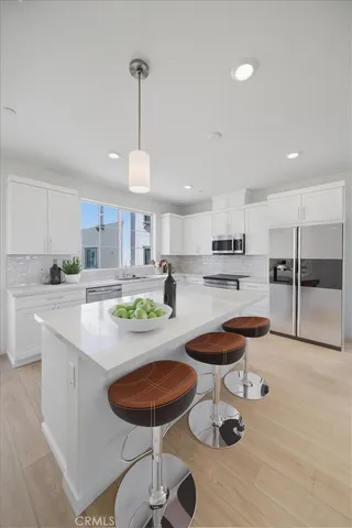 a kitchen with stainless steel appliances kitchen island granite countertop a sink and cabinets