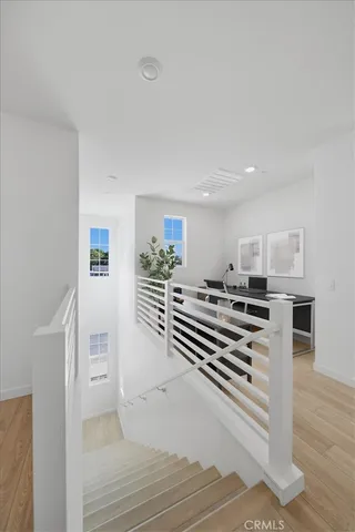 a view of a room with wooden floor and stairs