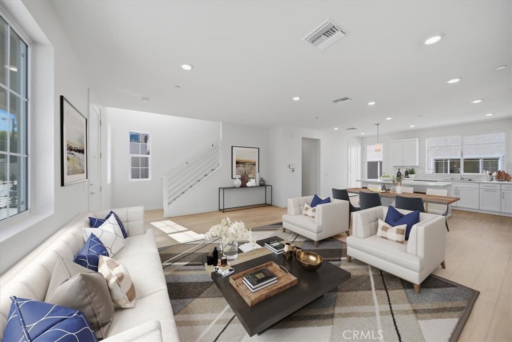 4841 East Beltramo Ranch Road Moorpark, CA 93021 - Photo 4 of 38 a living room with furniture couches and a dining table with wooden floor