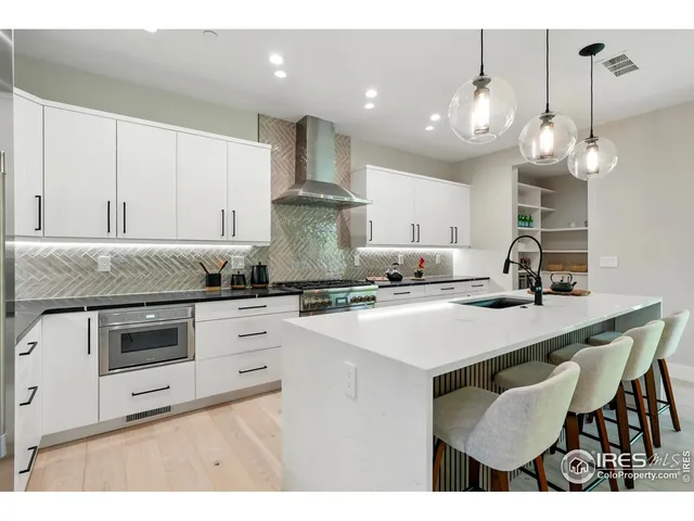 a kitchen with a sink stainless steel appliances and cabinets