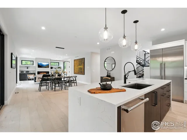 a kitchen with sink a stove and chairs