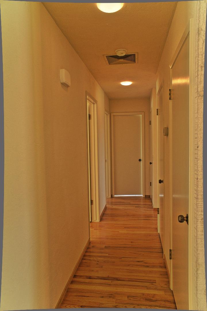 3035 Sloat Road Pebble Beach, CA 93953 - Photo 15 of 16 a view of a hallway with wooden floor