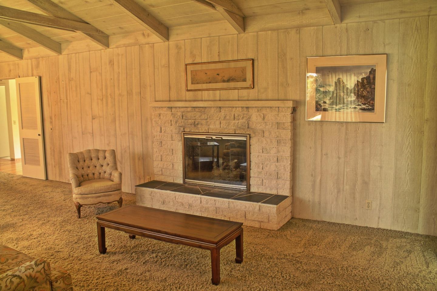 3035 Sloat Road Pebble Beach, CA 93953 - Photo 2 of 16 a living room with furniture and a fireplace