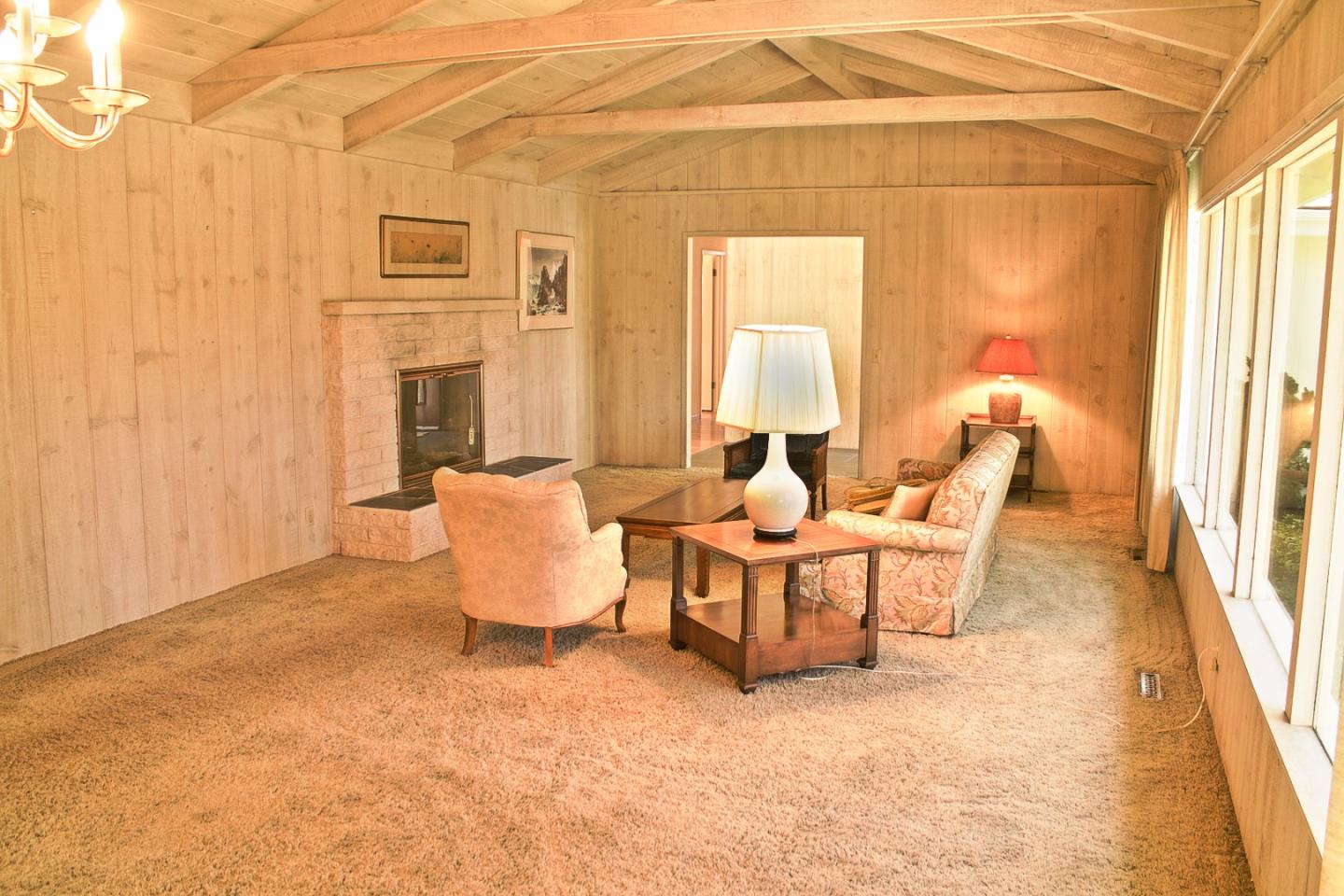 3035 Sloat Road Pebble Beach, CA 93953 - Photo 4 of 16 a living room with furniture and a fireplace