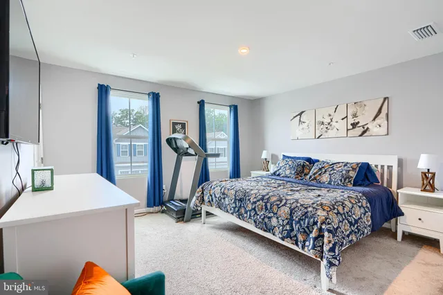 a bedroom with a bed and a desk