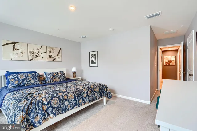 a bedroom with a large bed and a couch