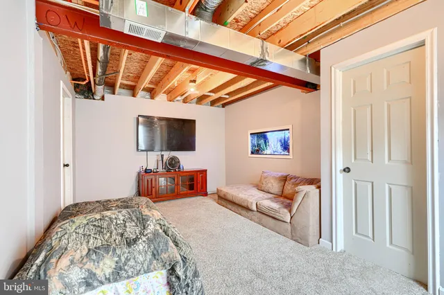 a bedroom with furniture and flat screen tv