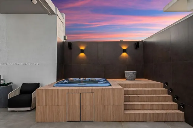 a living room with furniture a large window and kitchen view