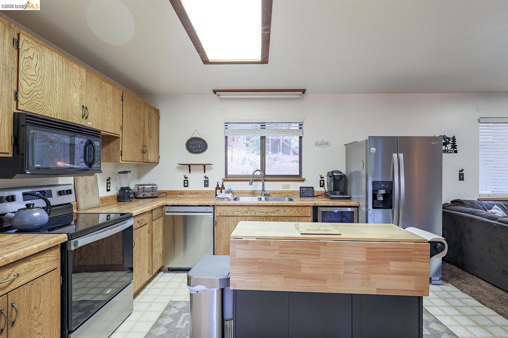 26600 Inyo Drive Cold Springs, CA 95335 - Photo 9 of 38 a kitchen with kitchen island a sink stove and refrigerator
