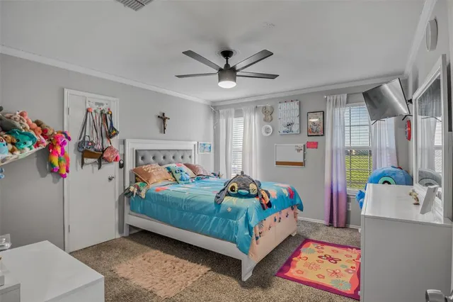 a bedroom with a bed a window and dresser