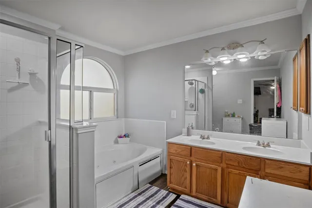 a bathroom with a tub sink shower and mirror