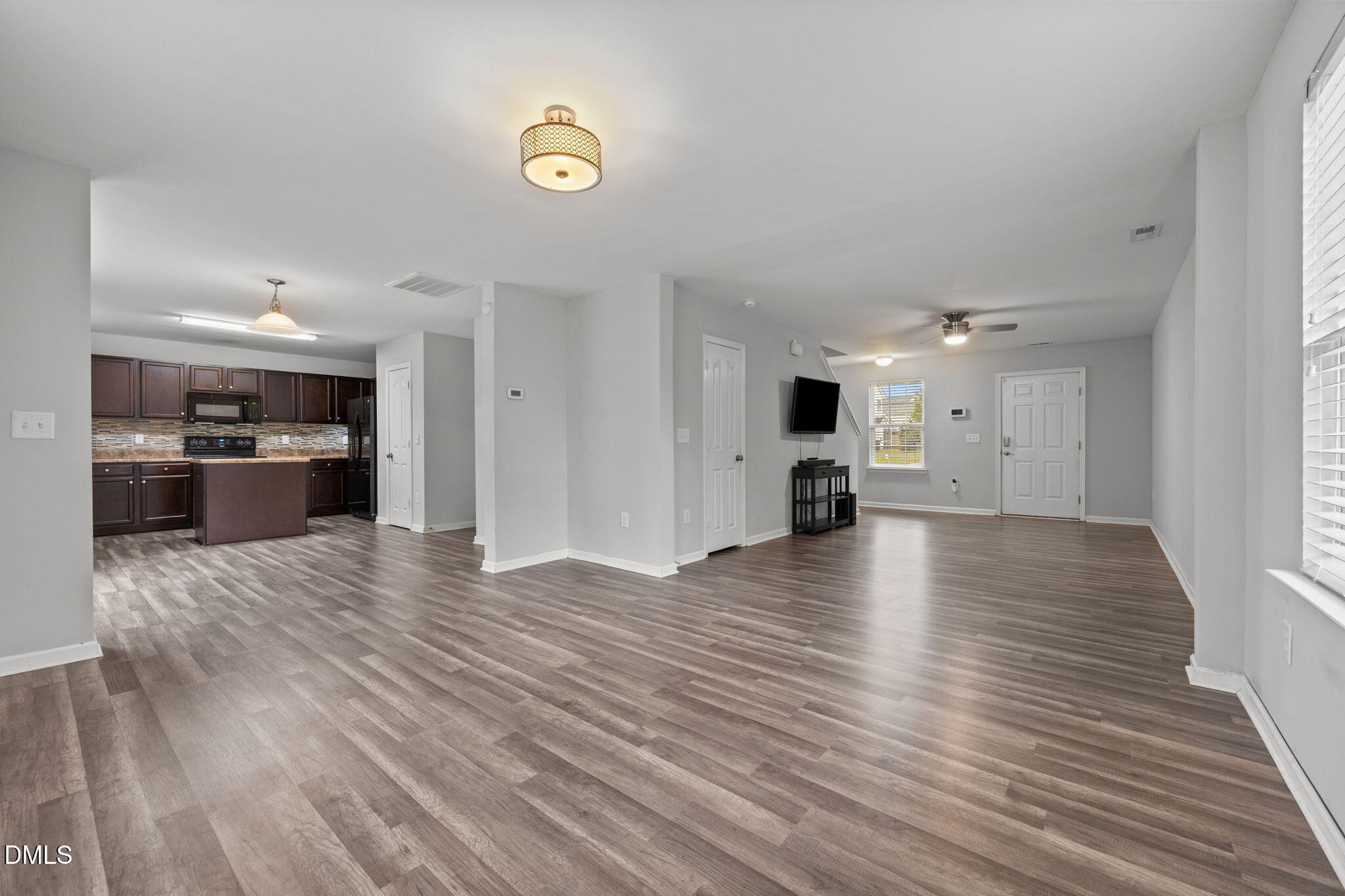45 Crane Way Bunnlevel, NC 28323 - Photo 10 of 35 a view of empty room with wooden floor and kitchen
