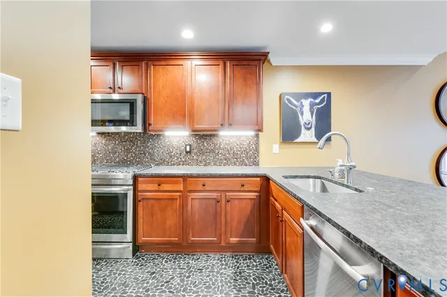 a kitchen with stainless steel appliances granite countertop a sink stove and cabinets