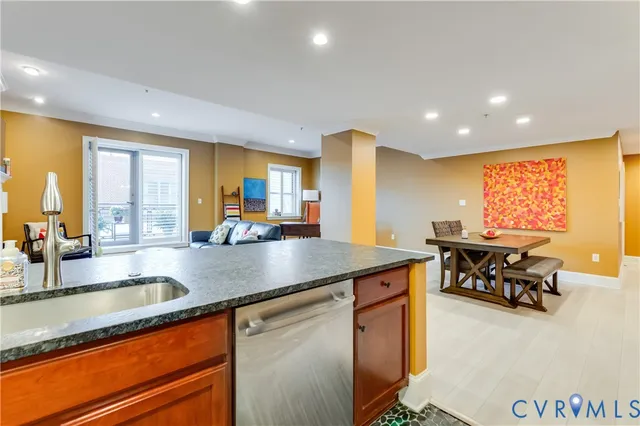 a kitchen with stainless steel appliances granite countertop sink stove and dining table