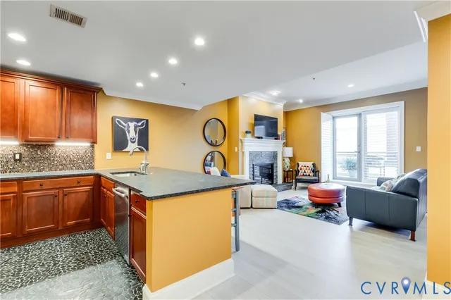 a kitchen with stainless steel appliances granite countertop sink stove and large window