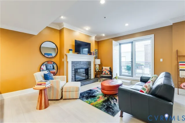 a living room with fireplace furniture and a large window
