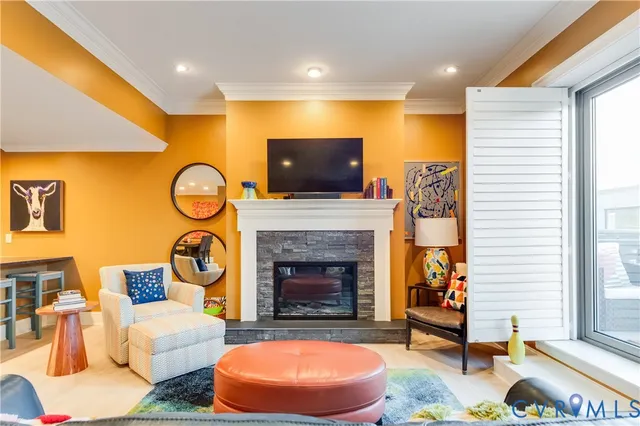 a living room with furniture a fireplace and a flat screen tv