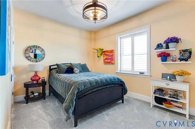 a view of hallway with paintings on the wall