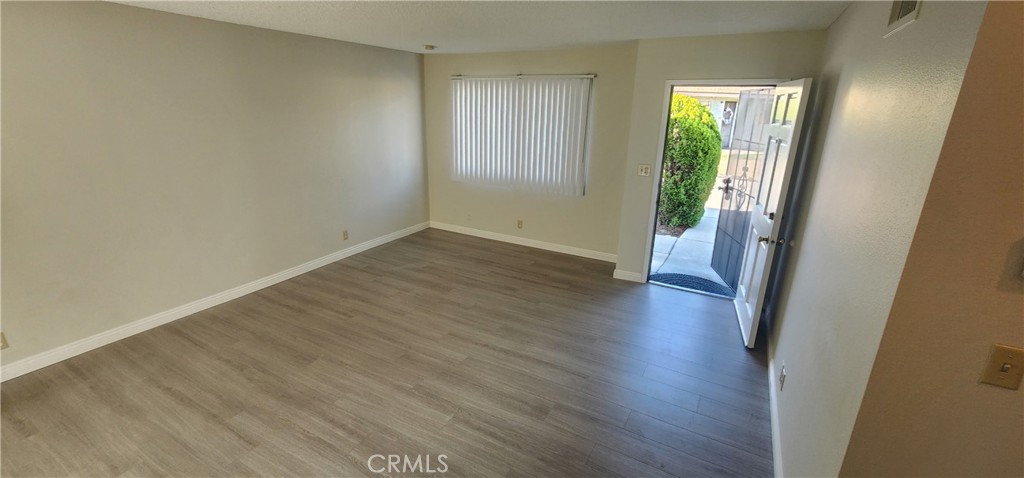 455 West Duell Street Azusa, CA 91702 - Photo 4 of 13 an empty room with wooden floor and windows