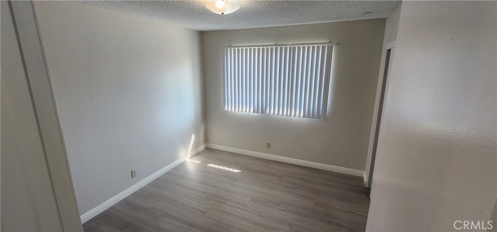 455 West Duell Street Azusa, CA 91702 - Photo 7 of 13 an empty room with wooden floor and windows