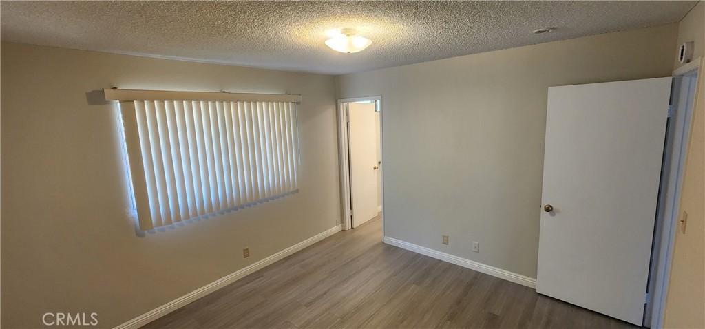 455 West Duell Street Azusa, CA 91702 - Photo 9 of 13 an empty room with wooden floor and windows