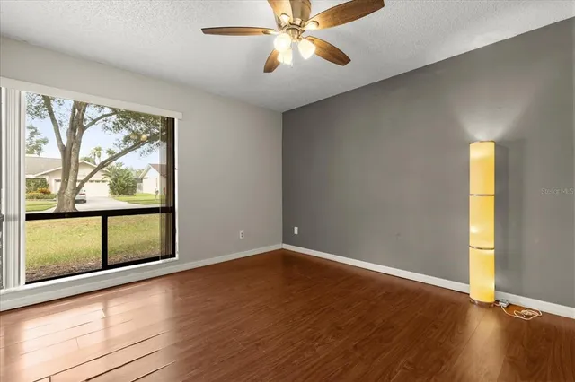 wooden floor in an empty room with a window